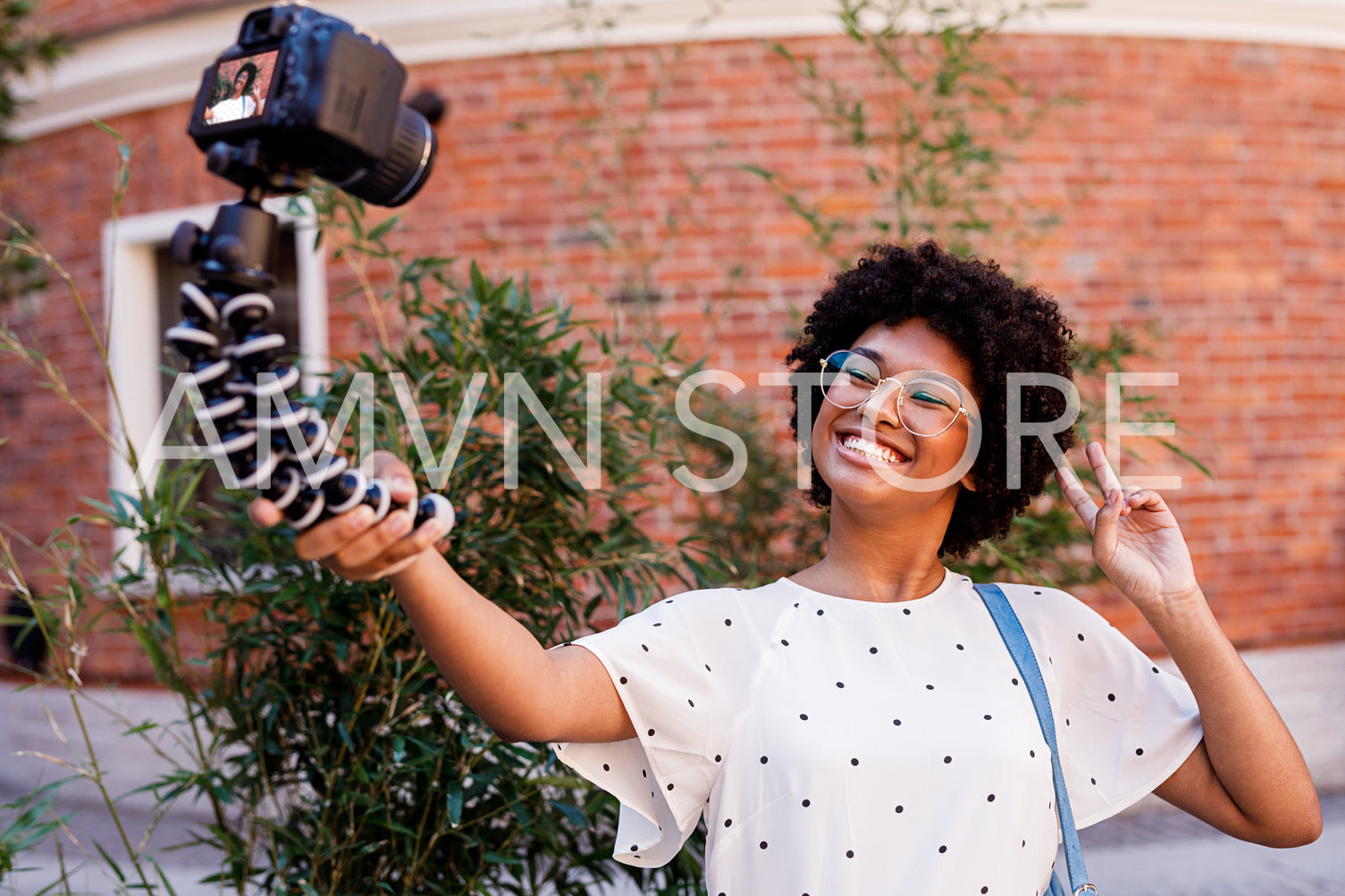 Happy girl filming on digital camera. Young vlogger making content.	