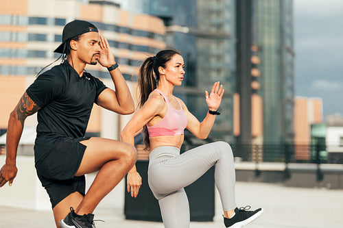 Muscular athletes jumping and running on the rooftop