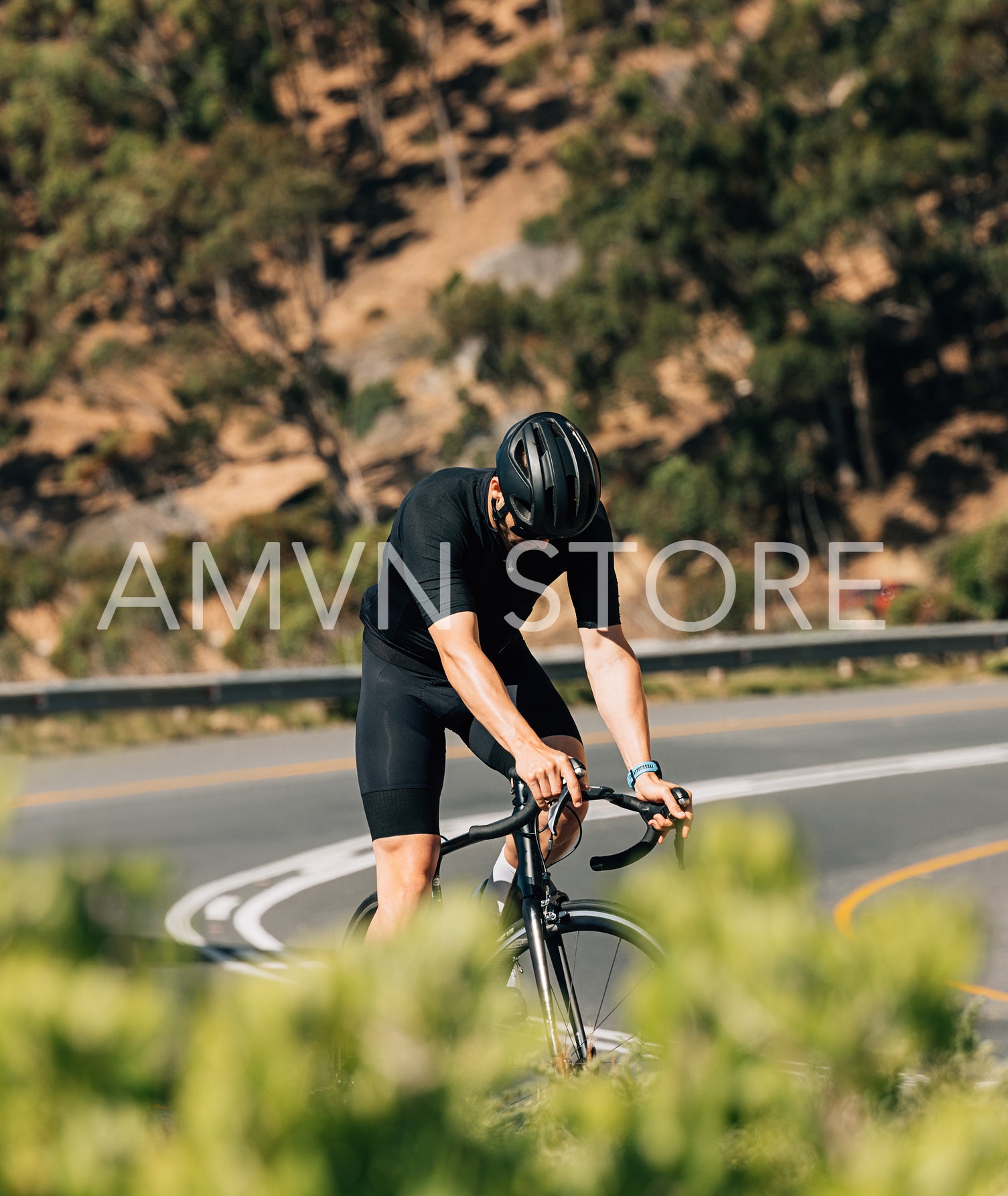 Fit cyclist taking a break on the road during the ride