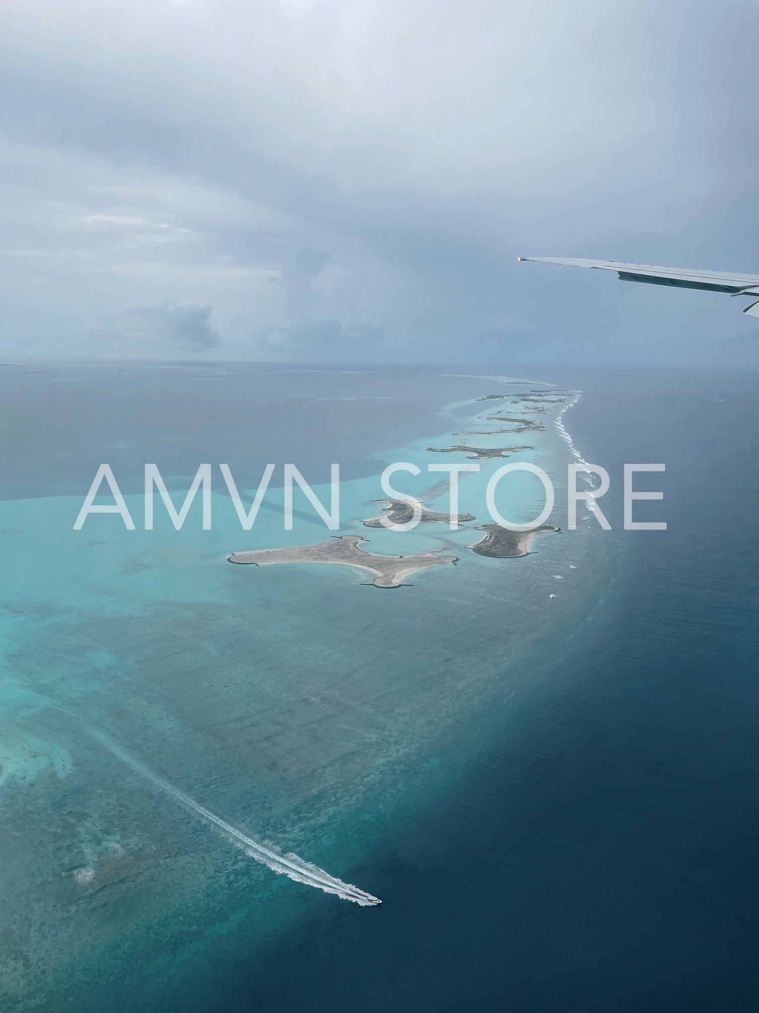 View from airplane on an ocean and big coral reef