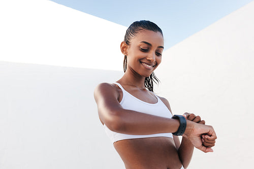 Slim cheerful female checking her pulse