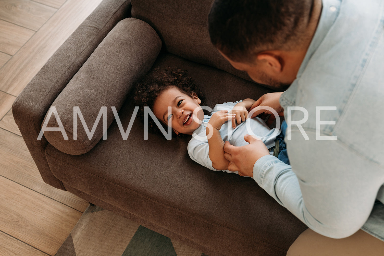 High-angle view of a father tickling his son