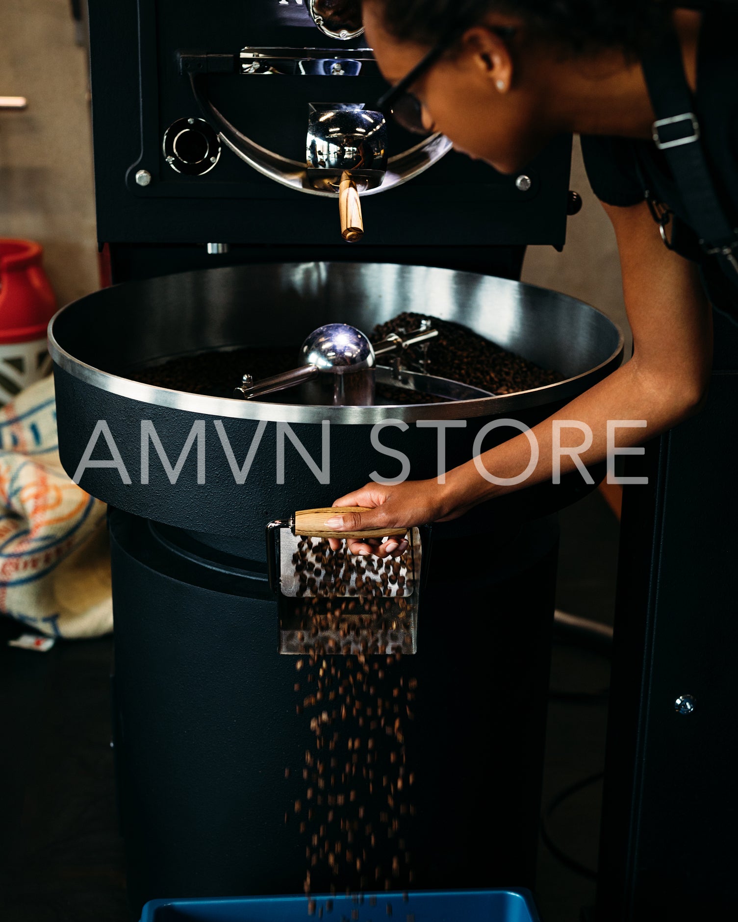 Woman working at roasting coffee machine	