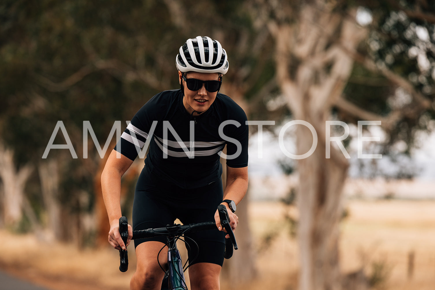 Professional female cyclist doing intense ride out of the saddle on road bike