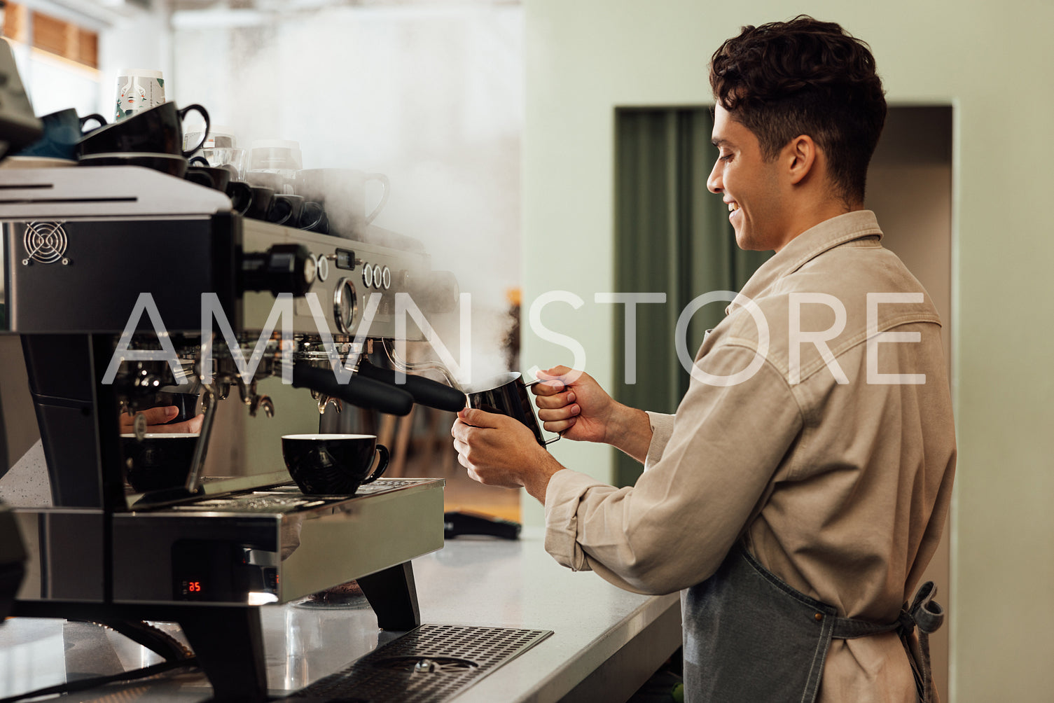 Side view of a barista using a coffee machine. Coffee shop owner preparing coffee.