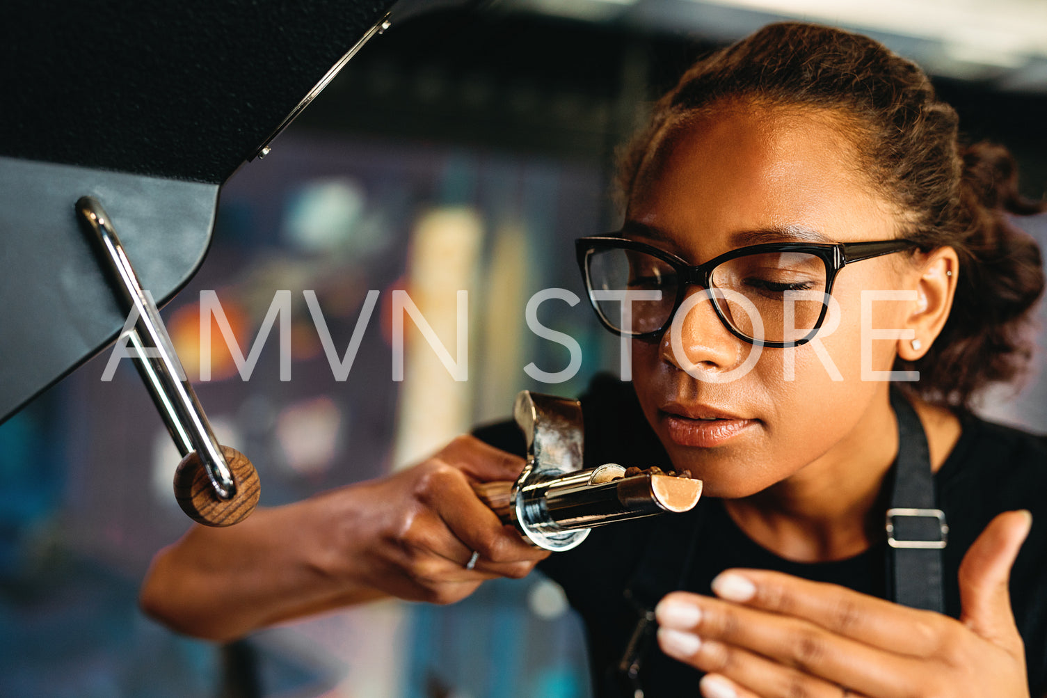 Close up of business owner checking the aroma of roasted coffee beans	