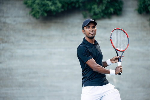 Male tennis player with racket during a match