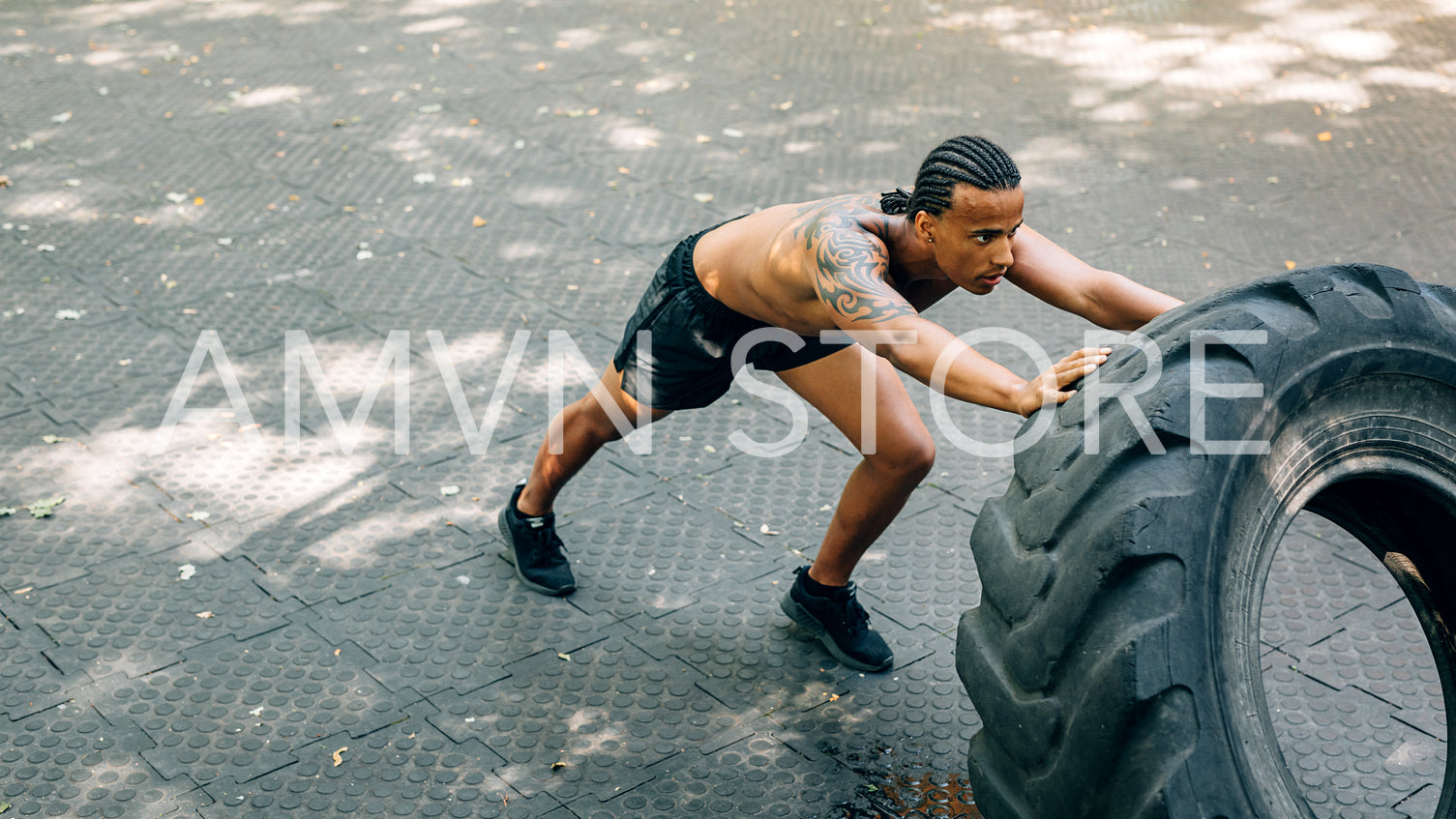 Man working out with heavy tire outdoors	