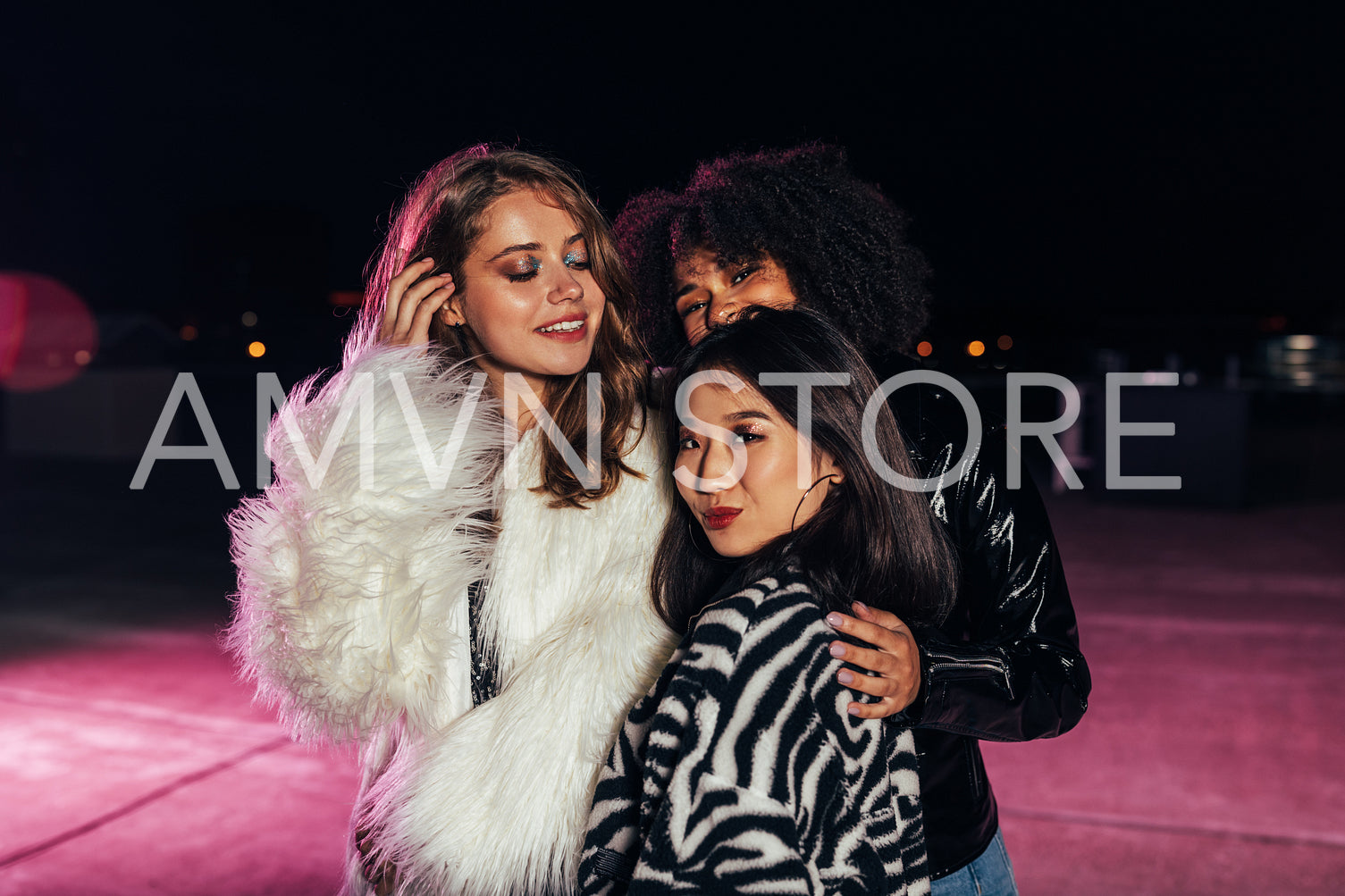 Multiethnic group of stylish girls standing together on roof	