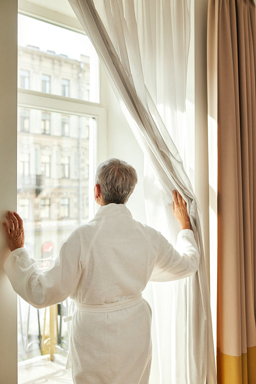 Back view of mature woman in bathrobe