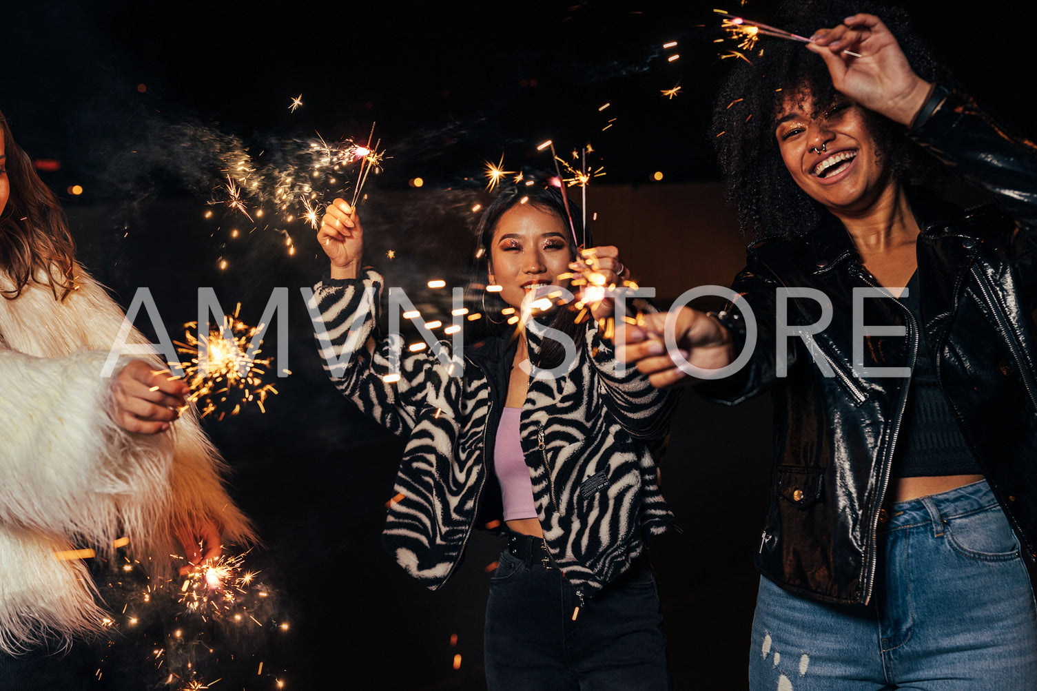 Close up of young girls holding sparklers and having fun on the parking lot	