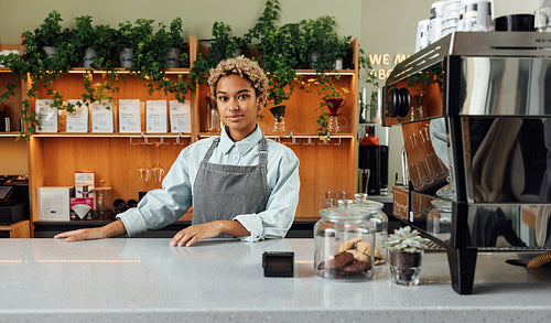 Barista at counter with a coffee machine