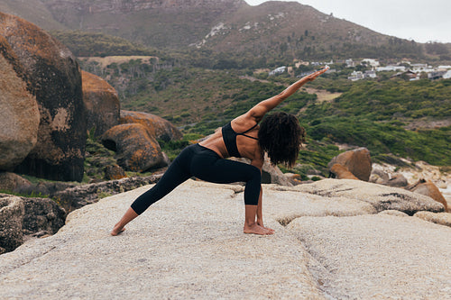 Healthy woman exercising outdoors at beautiful landscape.