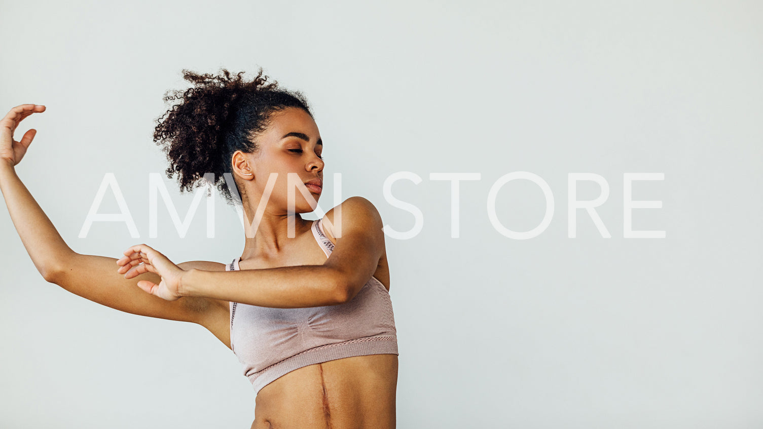 Young woman practicing dancing moves with hands in the studio	