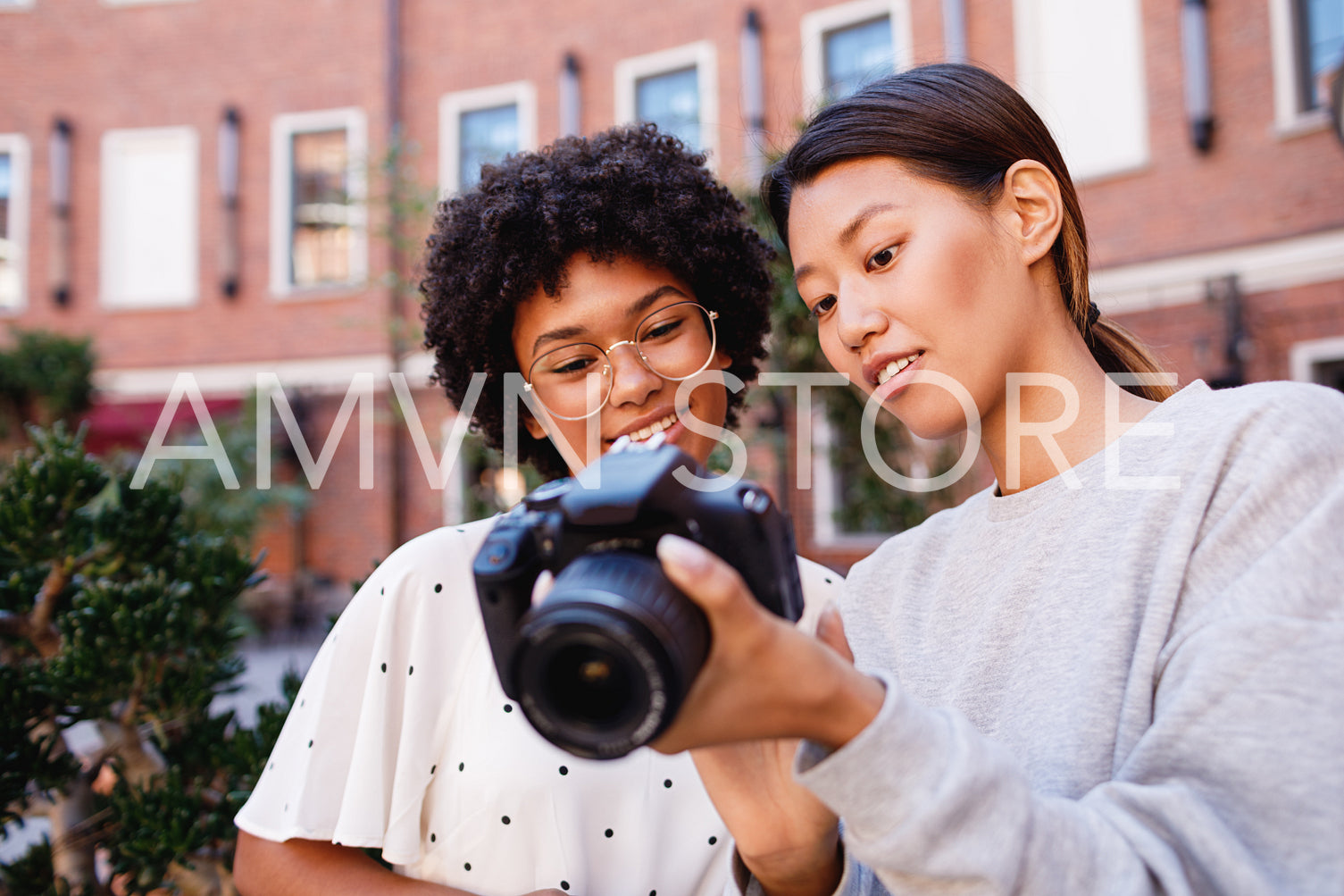 Photographer showing results of shoot to client	