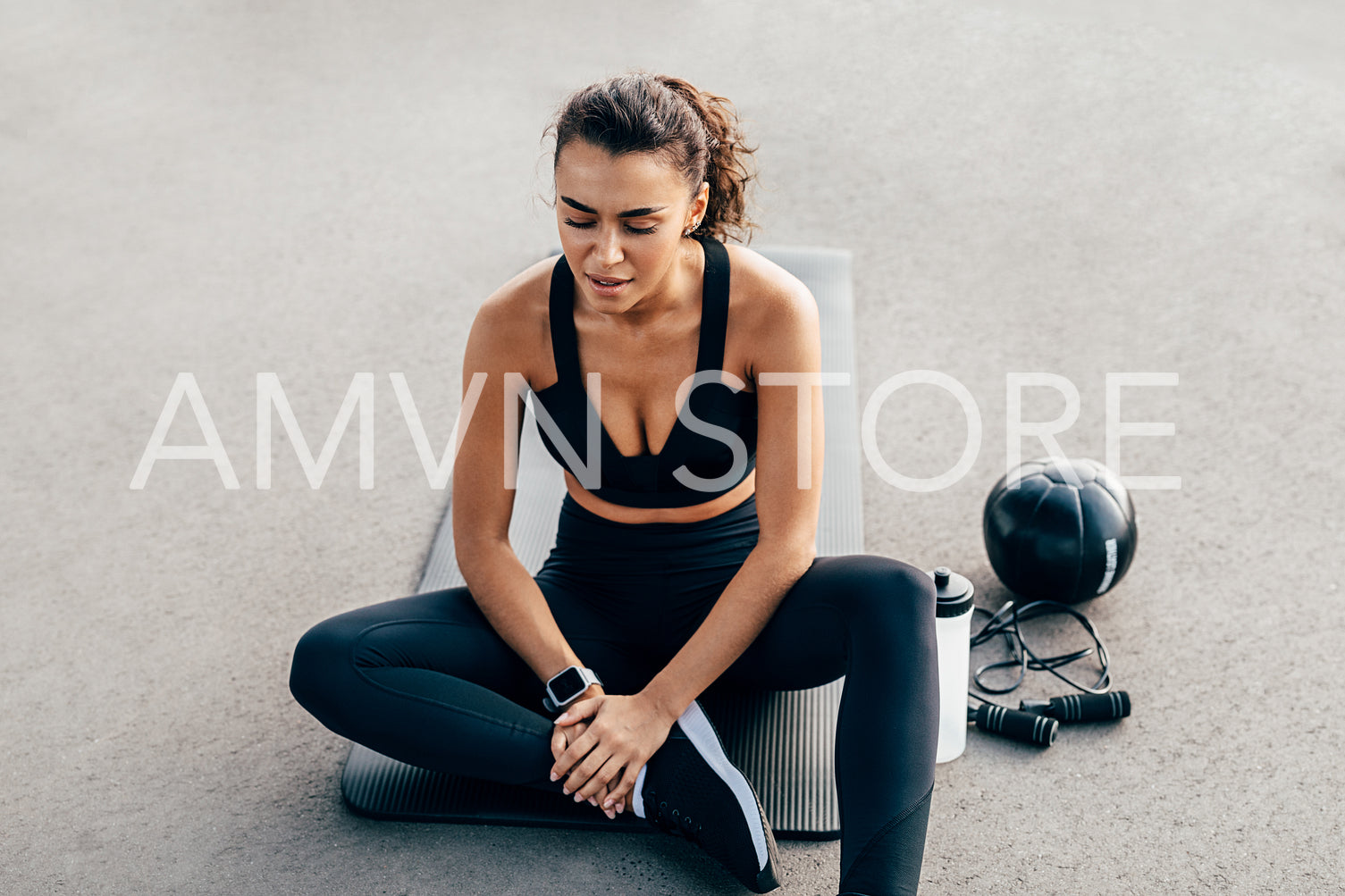 Exhausted woman resting after an intense workout on a mat with closed eyes	