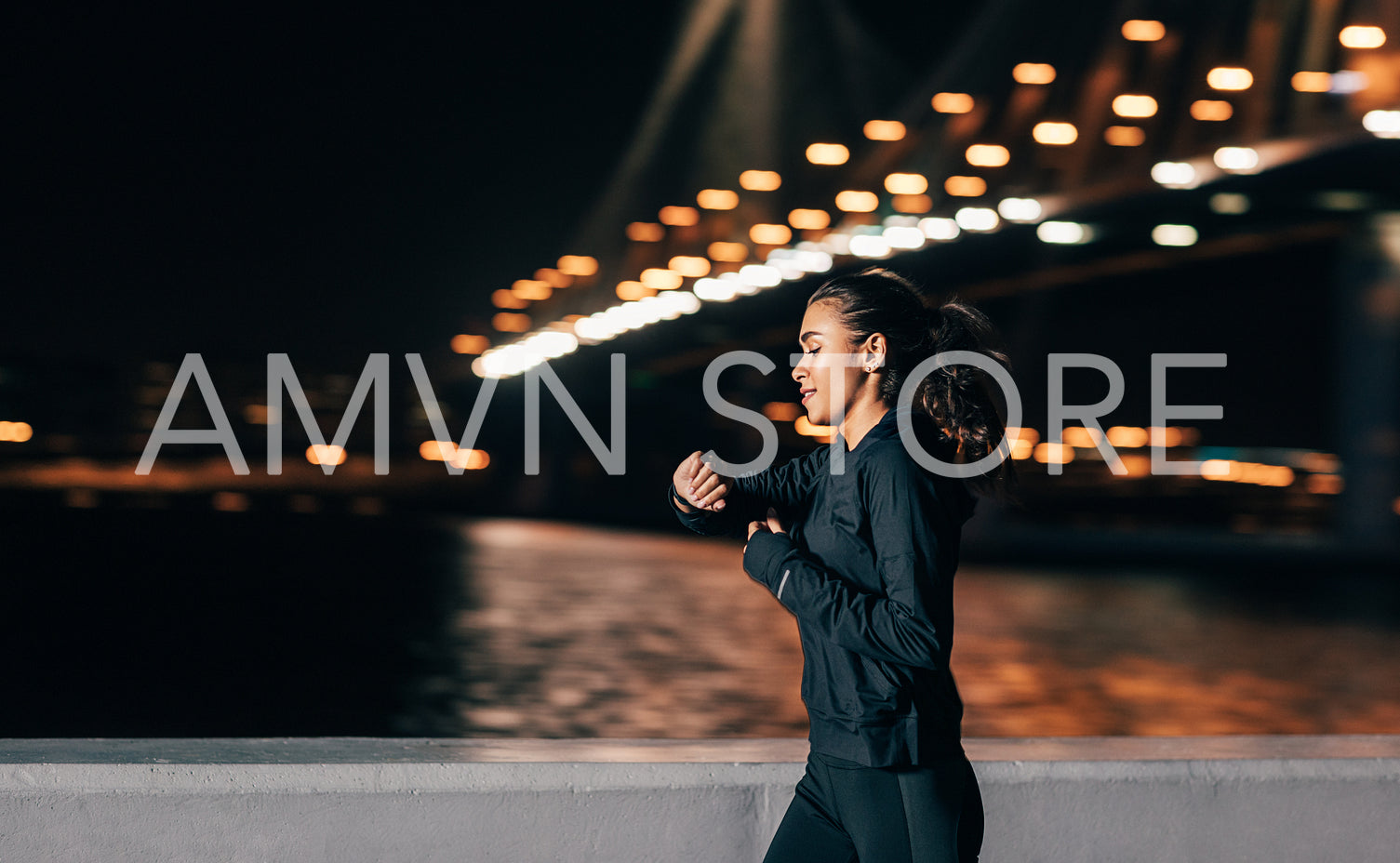 Young middle east woman jogging at night looking in fitness tracker on her wrist