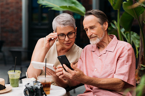 Woman looking at her husband's smartphone