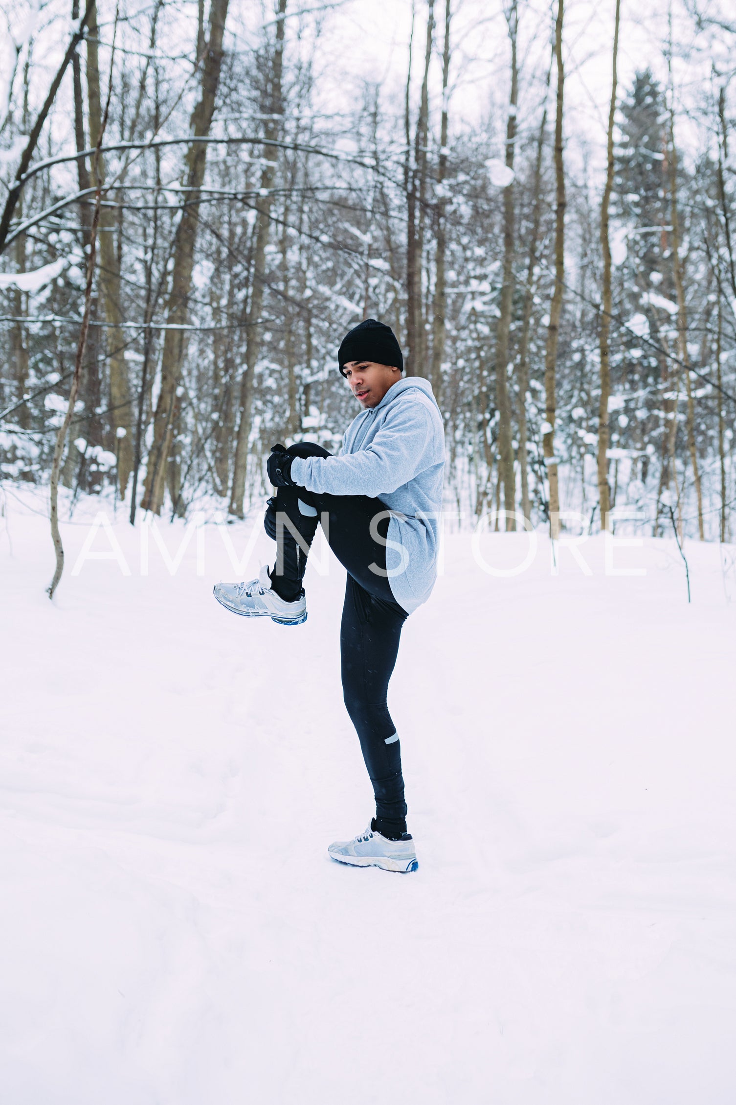 Male athlete doing stretching exercises. Fit male warming up outdoors.	
