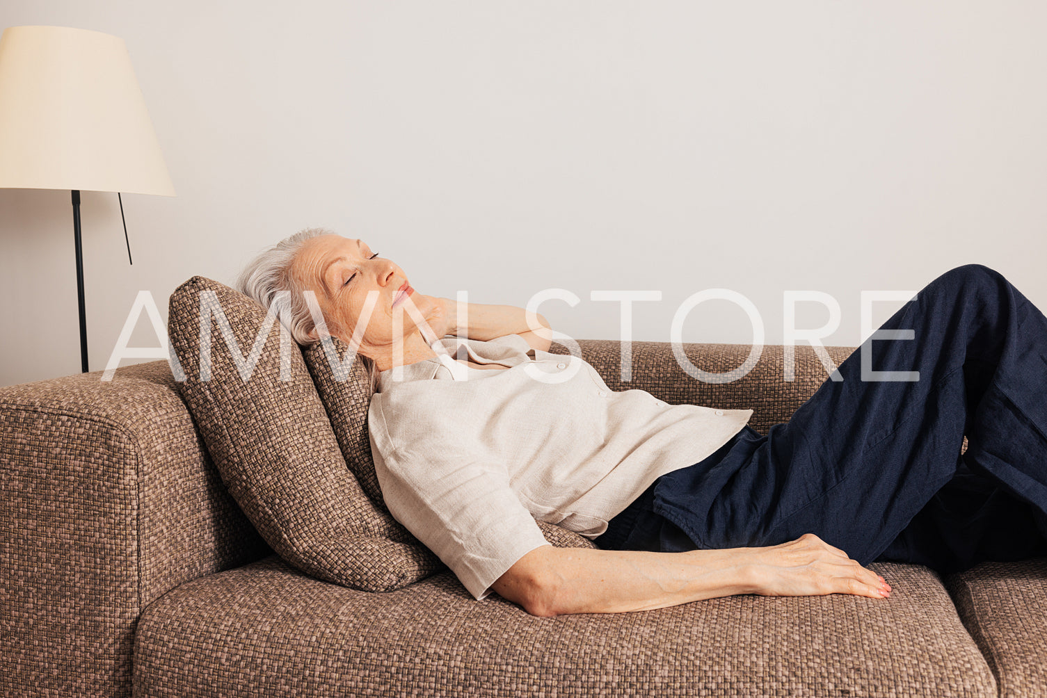 Aged woman sleeping on a couch