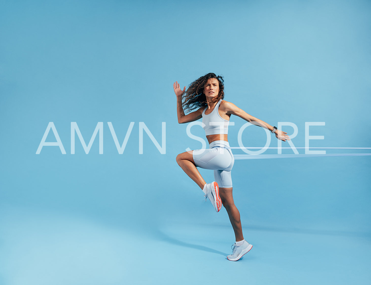 Woman exercising with resistance band on blue background. Caucasian female athlete working out with elastic bands.